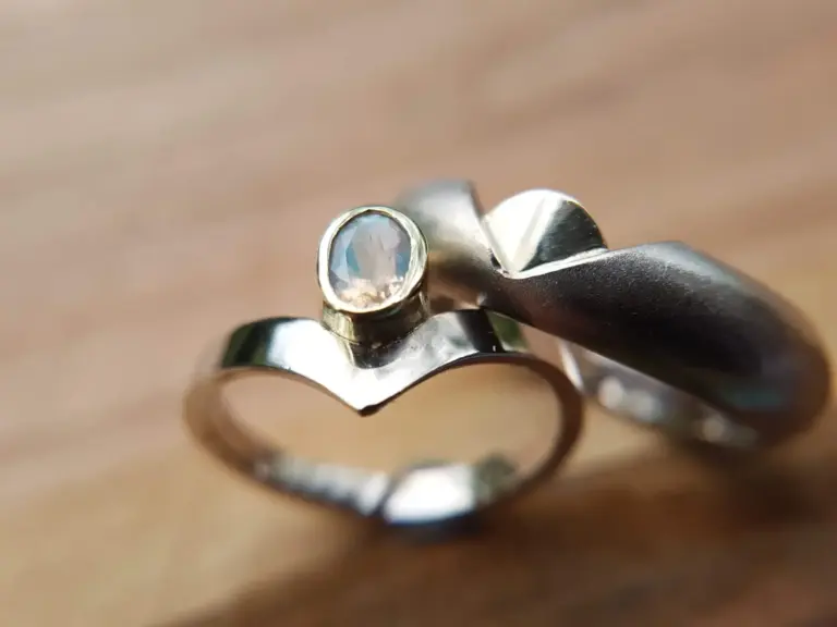 Close-up of a silver ring with a clear, faceted gemstone.